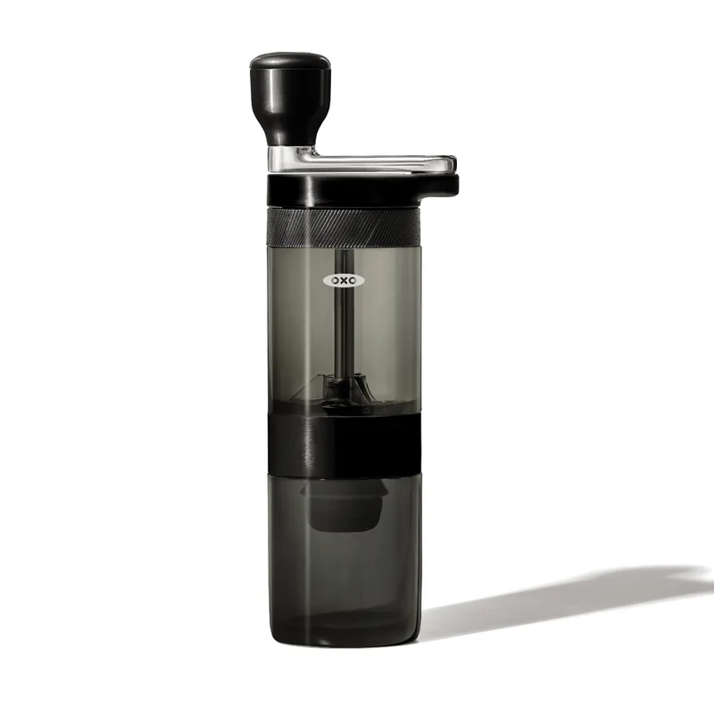 Manual Coffee Grinder in matte black with pivoting handle and clear hopper/grounds container